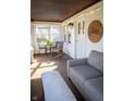 Cozy sunroom featuring neutral furniture, natural light, and string lights for a relaxing ambiance at 619 Kessler Blvd E Dr, Indianapolis, IN 46220