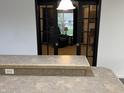 Living room view through glass doors showcases a cozy interior with a comfortable chair and natural light at 6431 W 800 S, Pendleton, IN 46064