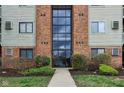 Brick building entrance featuring a glass facade and well-maintained landscaping and clearly visible address at 7220 Village Parkway Dr # 8, Indianapolis, IN 46254