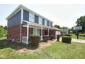 Beautiful two-story home with brick accents, a front porch, and a two-car garage at 7421 Rogers Dr, Indianapolis, IN 46214
