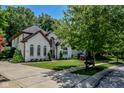 A well-manicured front yard complements this brick facade, two-story home featuring multiple archways and professional landscaping at 7957 Preservation Dr, Indianapolis, IN 46278