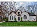 Charming brick two-story home with manicured lawn, arched windows, and a grand entrance at 7957 Preservation Dr, Indianapolis, IN 46278