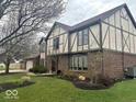 Charming two-story home with brick and Tudor accents and lush landscaping at 8212 N Sierra Dr, Muncie, IN 47303
