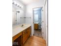 Bathroom featuring double sinks, white counters, and view of the adjacent bathroom at 9029 Crook N Dr, Indianapolis, IN 46256