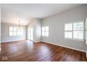 Bright living room featuring wood floors, plantation shutters and a sliding door at 9029 Crook N Dr, Indianapolis, IN 46256
