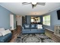 Open-concept living room with stylish furnishings, hardwood flooring, and plenty of natural light from the adjacent windows at 10622 Young Lake Dr, Indianapolis, IN 46239