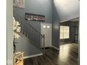 Bright and airy foyer with hardwood floors, staircase, and modern decor at 1071 Hazelwood Dr, Greenwood, IN 46143