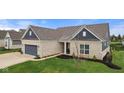 Attractive single-story home with a two-car garage, well-kept lawn, and inviting front porch at 11450 Wicker Ln, Noblesville, IN 46060