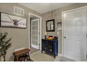 Inviting foyer with tile flooring, a stylish console table, and decorative art enhancing the entryway at 12658 Watford Way, Fishers, IN 46037