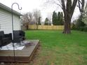 A large fenced-in backyard with a wooden deck, perfect for outdoor relaxation and entertaining at 150 E Carlisle St, Mooresville, IN 46158