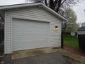A clean white garage with paneled door and exterior lighting offering secure parking and storage at 150 E Carlisle St, Mooresville, IN 46158