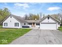 Charming single-story home with a white painted brick facade, attached garage, and well-maintained lawn at 1520 E 87Th St, Indianapolis, IN 46240