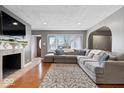 Comfortable living room with a large sectional, fireplace, hardwood floors, and ample natural light at 1520 E 87Th St, Indianapolis, IN 46240