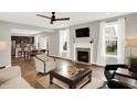 An inviting living room with a fireplace that is open to the kitchen and dining area at 16491 Wheatley Ct, Fishers, IN 46040
