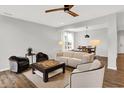 A modern living room with hardwood floors, stylish seating, and natural light at 16491 Wheatley Ct, Fishers, IN 46040