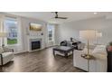 Bright living room featuring a fireplace, hardwood floors, and modern furnishings at 16491 Wheatley Ct, Fishers, IN 46040