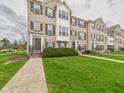 Well-maintained brick townhomes boast lush green lawns at 170 Straughn Ln, Westfield, IN 46074