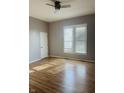 Cozy bedroom with hardwood floors, a ceiling fan, and sunlit windows, perfect for relaxation at 1922 N Cherry St, Columbus, IN 47201