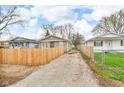 Wide driveway between fenced properties with ample space for parking and easy access at 2055 N Somerset Ave, Indianapolis, IN 46222