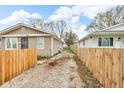 Wide driveway between fenced properties with ample space for parking and easy access at 2055 N Somerset Ave, Indianapolis, IN 46222