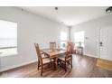 Bright dining room with wood floors, a wooden table with seating for four, and plenty of natural light at 2416 Meadow Bend Dr, Columbus, IN 47201