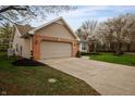 Beautiful single-story home showcasing brick accents, mature trees, and an extended driveway leading to the garage at 2813 W Long Meadow Ln, Muncie, IN 47304