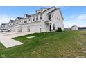 New construction townhomes with white siding, two-car garages, and green lawns at 3240 Arabian Ln, Zionsville, IN 46077