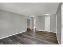 A view of the living room reveals gray walls, hardwood floors and access to multiple rooms at 3343 N Drexel Ave, Indianapolis, IN 46218