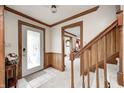 Inviting foyer features wood trim, neutral carpet, and staircase to the upper level at 3360 E Main St, Danville, IN 46122