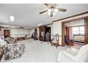 Spacious carpeted living room with wood trim, ceiling fan and an abundance of seating at 3360 E Main St, Danville, IN 46122