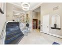 Elegant lobby featuring staircase, neutral paint, decorative lighting, lift and tiled flooring at 355 E Ohio St # 309, Indianapolis, IN 46204