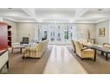 Comfortable lounge area with ample seating, neutral colors, and french doors with courtyard view at 355 E Ohio St # 309, Indianapolis, IN 46204