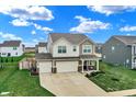 Charming two-story home featuring a spacious three-car garage and well-maintained lawn at 371 Bluestem Ln, Whiteland, IN 46184