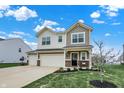 Charming two-story home featuring a spacious three-car garage and manicured lawn at 371 Bluestem Ln, Whiteland, IN 46184