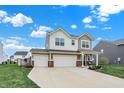 Charming two-story home featuring a spacious three-car garage and manicured lawn at 371 Bluestem Ln, Whiteland, IN 46184