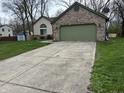 Large concrete driveway leading to an attached two-car garage at 3817 Cologne Ct, Indianapolis, IN 46228