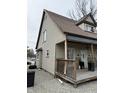 Home featuring a charming covered porch and a well-maintained exterior at 408 N Colorado Ave, Indianapolis, IN 46201