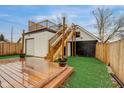 Exterior view of a wooden deck, garage, and artifical grass in the backyard at 415 S Oxford St, Indianapolis, IN 46201