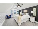Cozy bedroom featuring a queen-sized bed, accent chair, and stylish decor creating a relaxing ambiance at 415 S Oxford St, Indianapolis, IN 46201