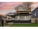 Charming two-story home with inviting front porch and upper-level deck, perfect for outdoor living at 415 S Oxford St, Indianapolis, IN 46201