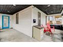 Charming front porch with secure package drop, a blue door, and two red chairs at 415 S Oxford St, Indianapolis, IN 46201