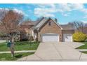 Lovely two-story brick home featuring an attached three-car garage at 4421 Brittany Dr, Zionsville, IN 46077