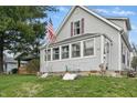 Charming gray home with well-maintained lawn and inviting curb appeal at 443 S Arlington Ave, Indianapolis, IN 46219