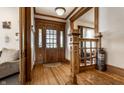 Inviting foyer with hardwood floors, wood trim, decorative staircase, and a vintage fire extinguisher at 4849 Central Ave, Indianapolis, IN 46205