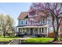 Beautiful two-story home with a classic facade, front porch, lush lawn, and inviting curb appeal at 4849 Central Ave, Indianapolis, IN 46205