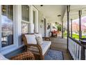 Cozy front porch featuring comfortable wicker furniture, a ceiling fan, and views of the surrounding neighborhood at 4849 Central Ave, Indianapolis, IN 46205