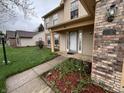 Inviting front porch with brick accents, manicured flower beds, and a well-lit entrance at 5814 Lakefield Dr, Indianapolis, IN 46254