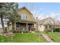 Lovely two-story home with a covered front porch, nestled in a neighborhood setting and mature landscaping at 616 N Bancroft St, Indianapolis, IN 46201