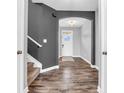 Warm entryway with hardwood floors, a staircase, and a view of the front door, offering a grand first impression at 682 Keswick Dr, Brownsburg, IN 46112