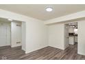 Bright, open-concept living room featuring modern flooring and an open doorway to the kitchen at 6853 Bretton Wood Dr, Indianapolis, IN 46268